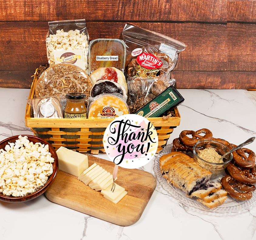 Best Thank You Gifts is a basket of gourmet cheese, baked goods, snacks, and spreads.